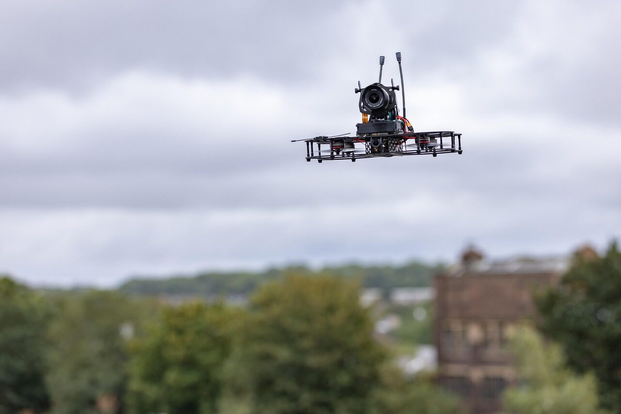 A modular surveillance drone ready for deployment, its interchangeable sensor payload fitted for a reconnaissance sortie.